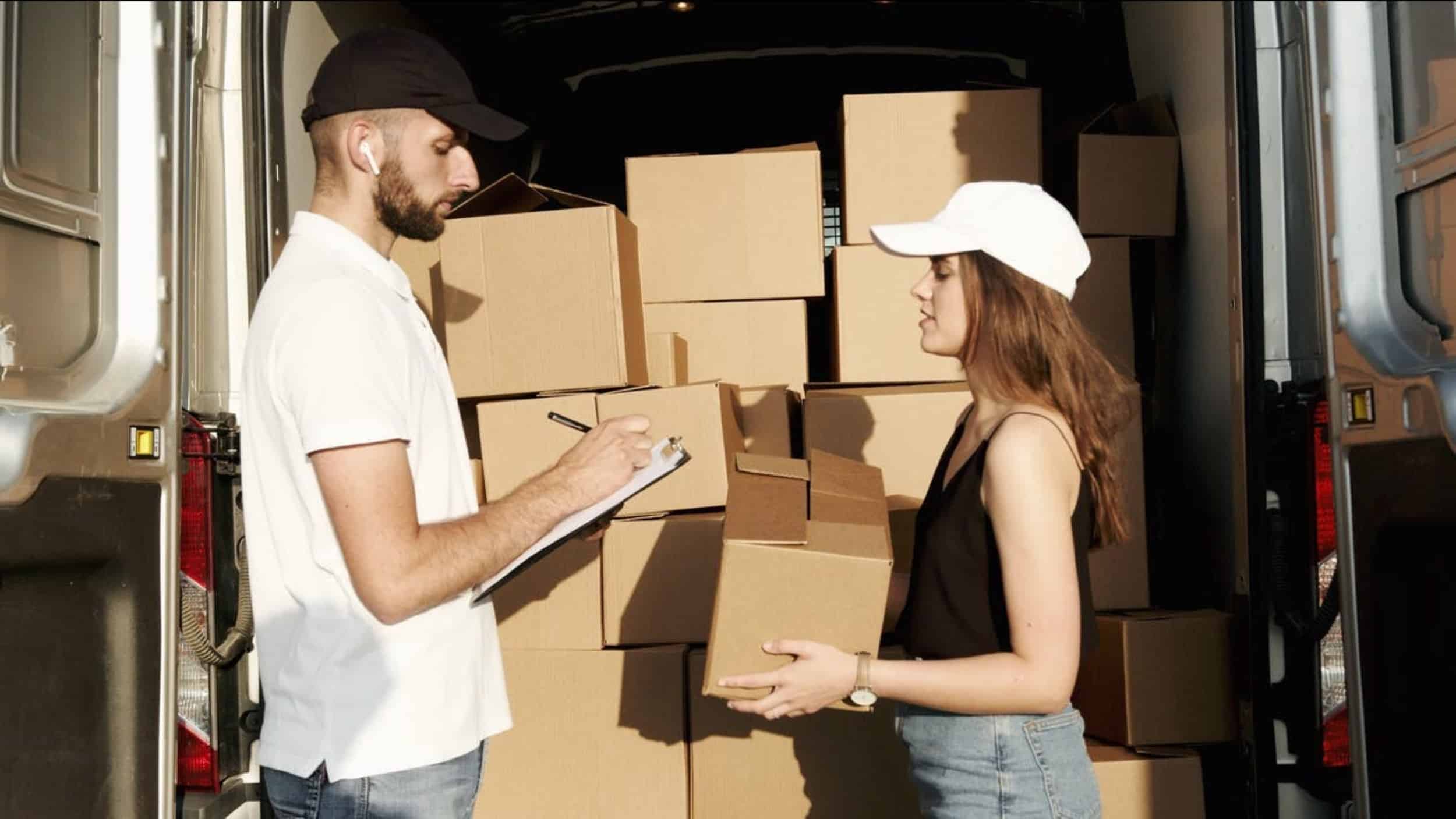 man and woman counting brown packing boxes