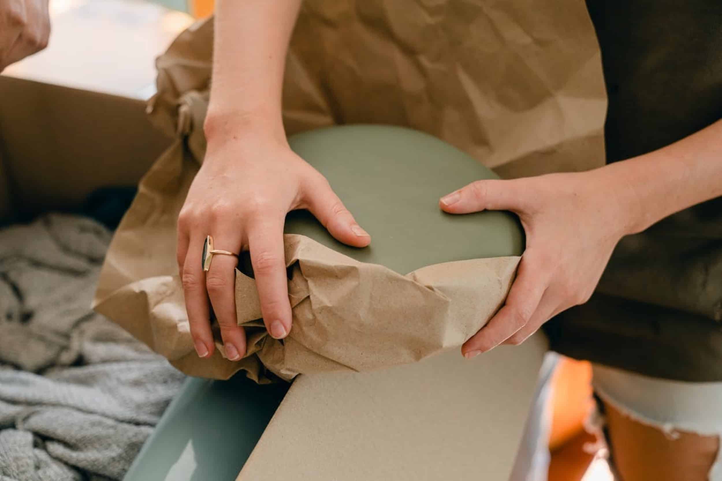 a woman packing with brown paper